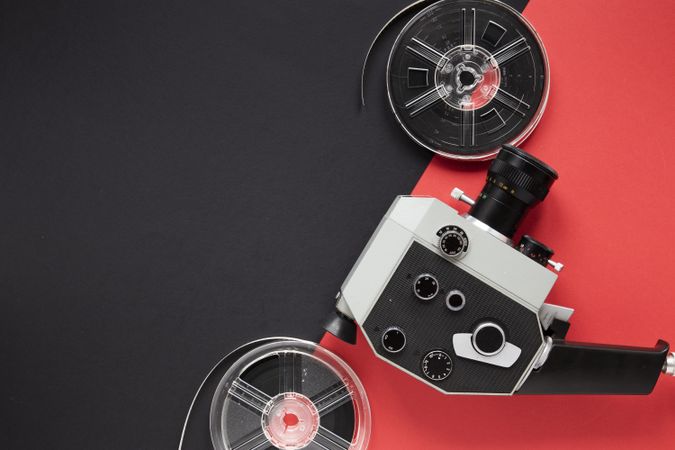 Camera on red background with film