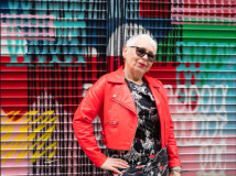 Grey Haired Woman In Red Leather Jacket With Hand On Hip Photo
